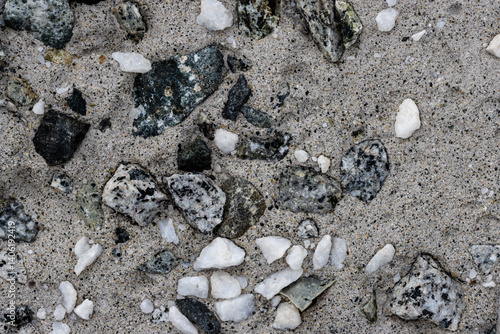 Obraz na płótnie Concrete wall texture with pebbles. Decorative rough concrete surface with white, black and gray stones. Perfect for background and design. Closeup. High resolution. w salonie