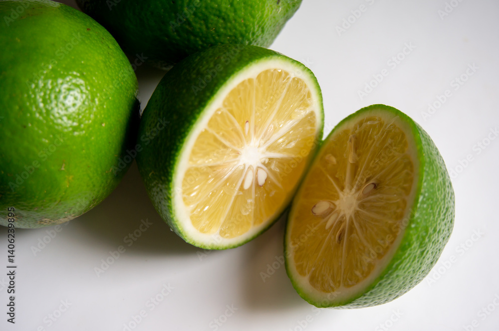 closeup fresh green lemon on a white background closeup fresh green lemon on a white background