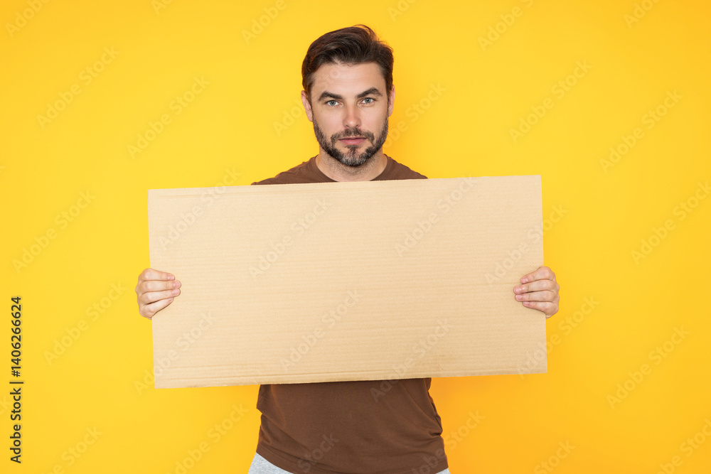 Man with empty blank banner ad on studio background. Portrait of attractive man holding empty blank poster. Man showing blank poster. Male presenting signboard, board or banner with copy space. Man with empty blank banner ad on studio background. Portrait of attractive man holding empty blank poster. Man showing blank poster. Male presenting signboard, board or banner with copy space.
