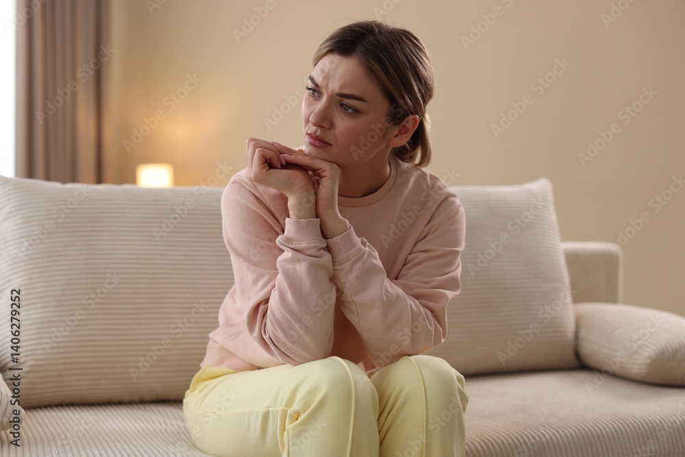 Depressed young woman on sofa at home Depressed young woman on sofa at home