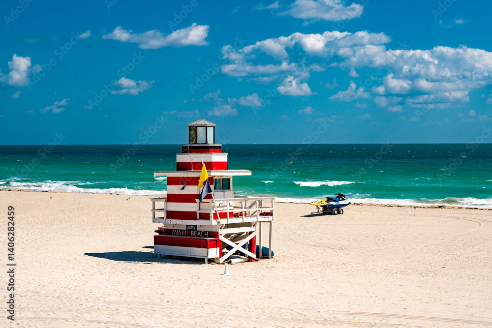 Fototapeta premium Miami pier. Jetty lifeguard tower on Miami Beach. Scenic view of Miami Beach coastline. Famous South Beach lifeguard. Tropical paradise in Miami. Art Deco lifeguard on Miamis beach.