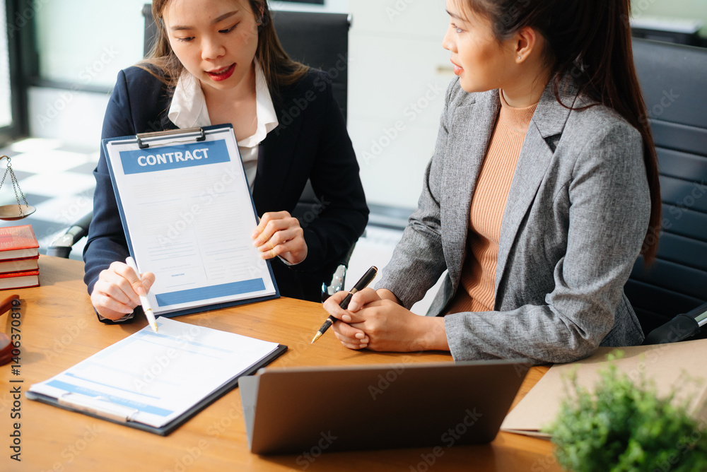 Two lawyers are discussing about contract paper, law matters determination, pointing.law and hammer Two lawyers are discussing about contract paper, law matters determination, pointing.law and hammer