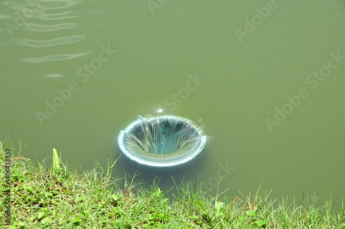 Wallpaper Mural Closeup of Small drainage holes inside the pond with natural background. The concept is to prevent water from rising too high at Thailand. Torontodigital.ca