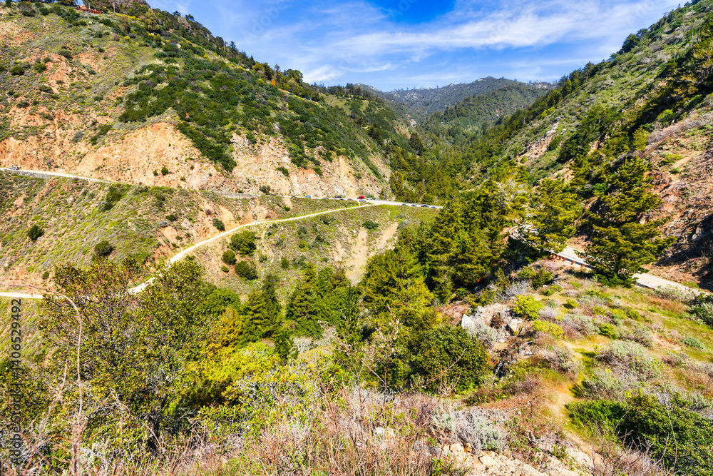Fototapeta premium Stunning coastal landscape along California's Highway 1, featuring rugged rocky formations, and the vast blue ocean. A breathtaking natural scene showcasing the raw beauty of the Pacific coastline