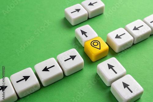 Illustrating navigation and choices, the image features white dice with directional arrows leading towards and away from a prominent yellow die marked with a location pin on a green surface with poten