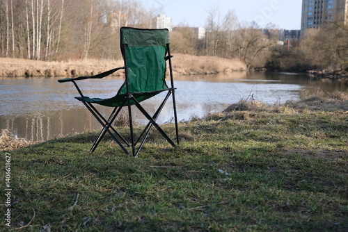 One folding chair for camping on the river bank. Fishing and outdoor recreation