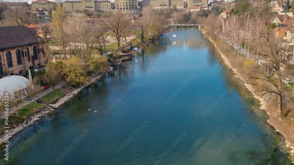 Scenic view of the emerald-green Aare River flowing past the Marzili district, with Switzerland’s Federal Palace (Bundeshaus) rising in the background beneath a partly cloudy spring sky. Scenic view of the emerald-green Aare River flowing past the Marzili district, with Switzerland’s Federal Palace (Bundeshaus) rising in the background beneath a partly cloudy spring sky.