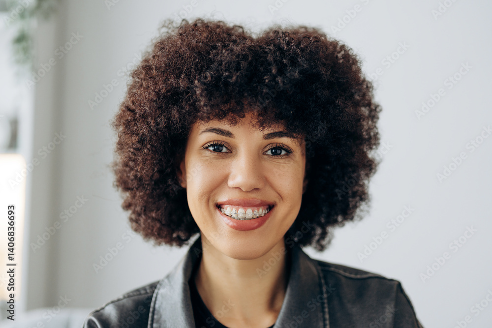 Portrait of African American woman smiling with braces and afro hairstyle Portrait of African American woman smiling with braces and afro hairstyle