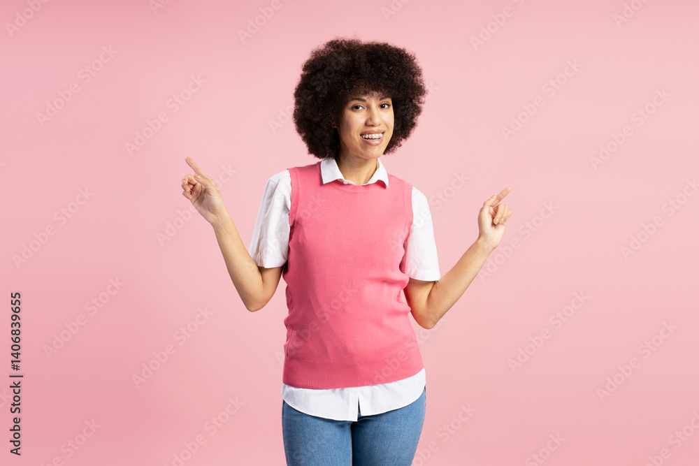 Young smiling African American woman pointing to both sides on pink background Young smiling African American woman pointing to both sides on pink background