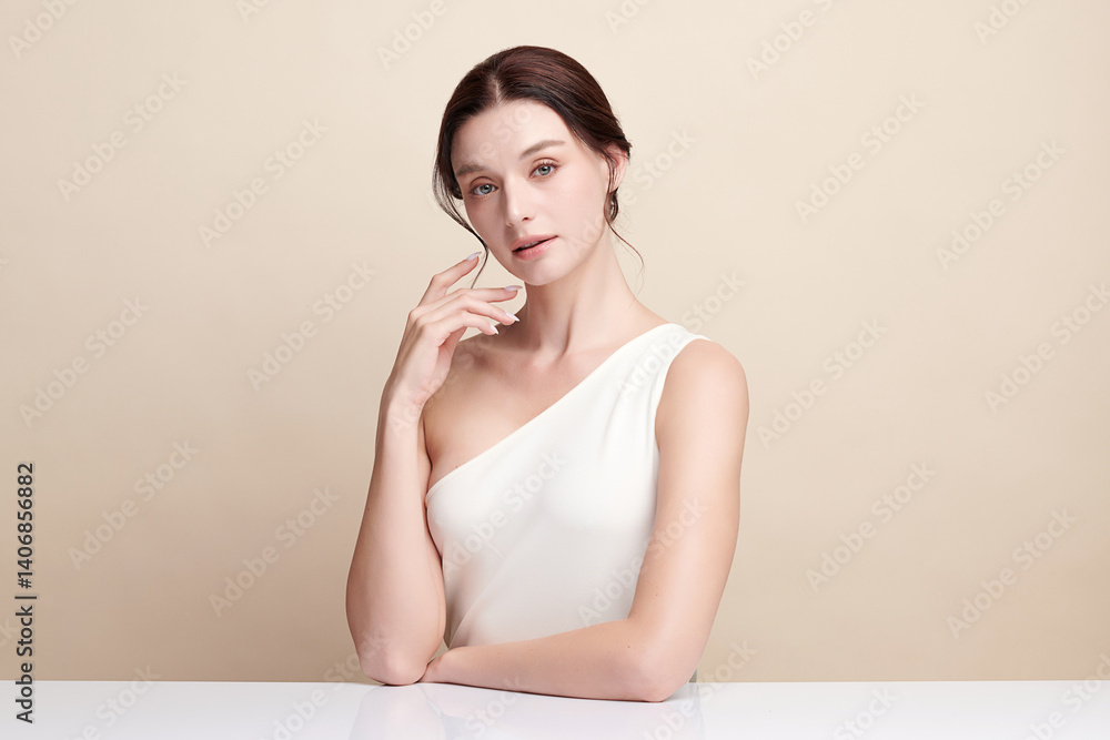 A beautiful young woman with clean, fresh skin against a beige background. Skincare, facial treatment, cosmetology, beauty, and spa. An elegant portrait of an woman. A beautiful young woman with clean, fresh skin against a beige background. Skincare, facial treatment, cosmetology, beauty, and spa. An elegant portrait of an woman.