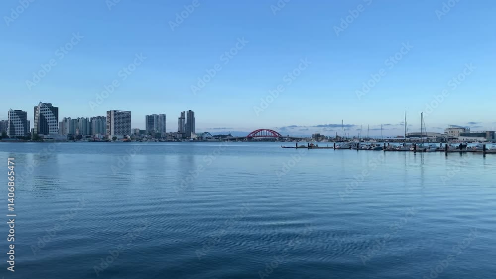 Panoramic, scenic view of Sokcho city skyline. High rise buildings, Seolak bridge. Yachts docked at marina, pier. Motion of sea waves. Sokcho, South Korea Panoramic, scenic view of Sokcho city skyline. High rise buildings, Seolak bridge. Yachts docked at marina, pier. Motion of sea waves. Sokcho, South Korea