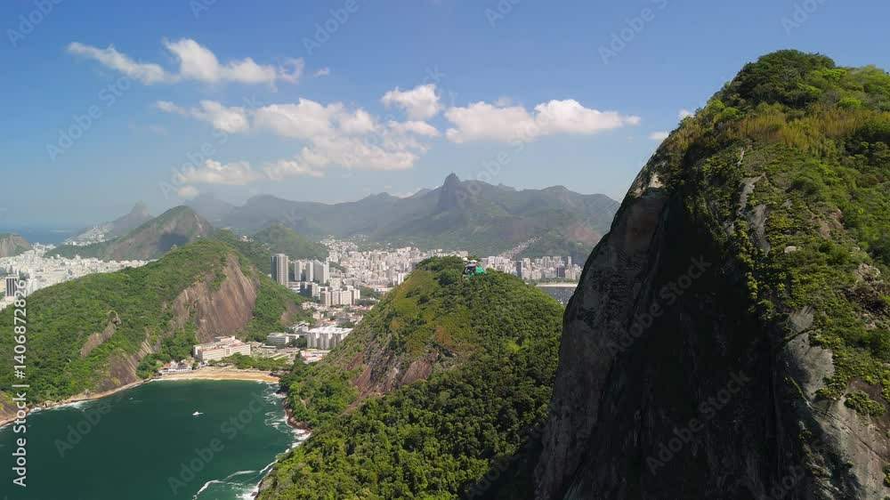 Aerial ascend of Sugarloaf Mountain with a pan left revealing the city of Rio de Janeiro Aerial ascend of Sugarloaf Mountain with a pan left revealing the city of Rio de Janeiro