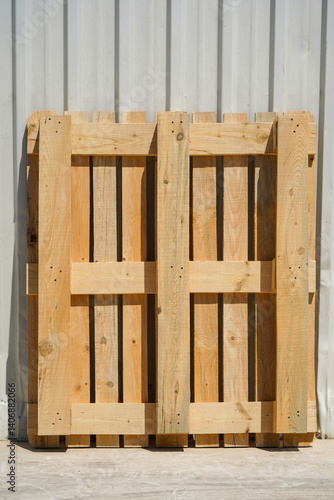 Obraz na płótnie Wooden Pallet Leaning Against a Metal Wall in Industrial Setting w salonie