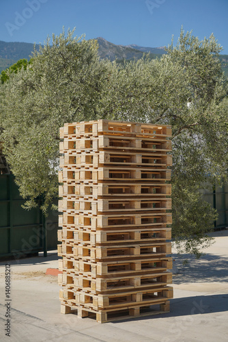 Obraz na płótnie Large pile of wooden pallets outdoors at the factory loading dock. w salonie