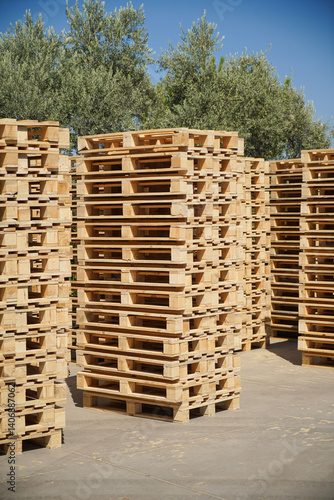 Obraz na płótnie Stacked Wooden Pallets Outdoors in a Storage Facility on a Sunny Day. w salonie