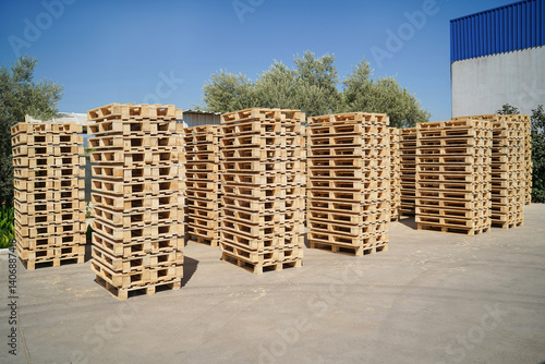 Obraz na płótnie Stacked Wooden Pallets Outdoors in a Storage Facility on a Sunny Day. w salonie