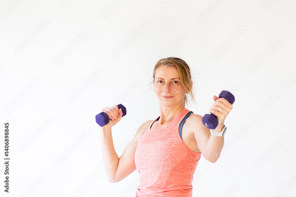 fit woman in her forties lifting weights