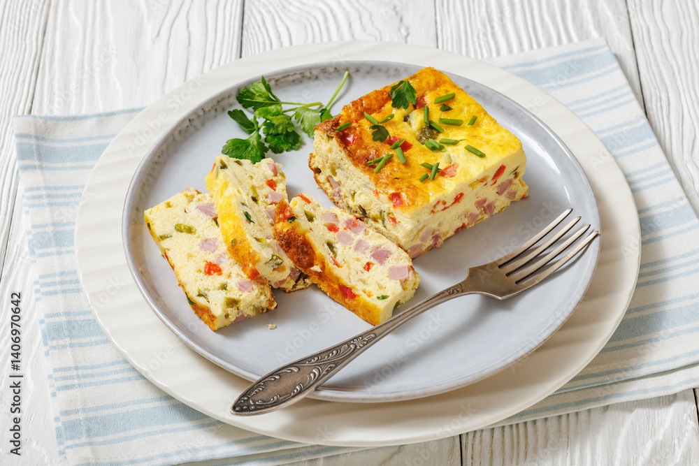 Baked Denver Omelette on a plate with fork Baked Denver Omelette on a plate with fork