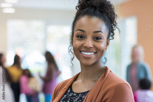 Social worker smiles warmly while engaging with community members in a vibrant center during afternoon outreach activities
