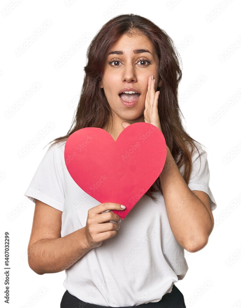 Middle Eastern woman holding paper heart shouting and holding palm near opened mouth. Middle Eastern woman holding paper heart shouting and holding palm near opened mouth.