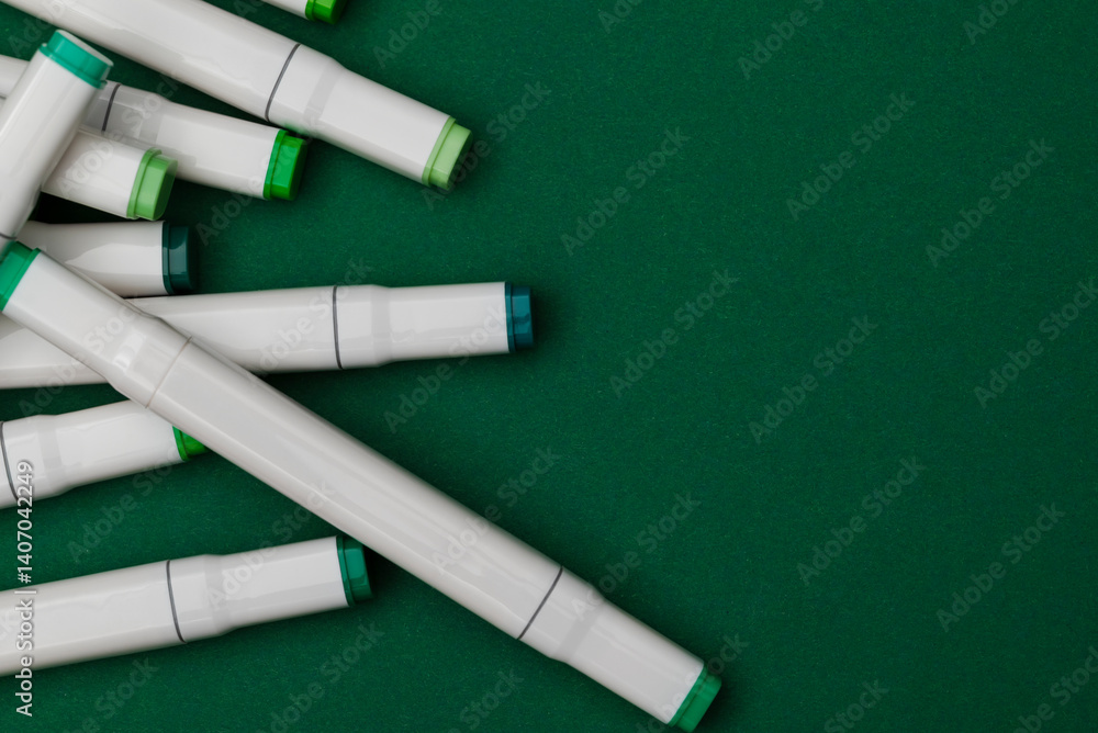 Several markers on a green background Several markers on a green background