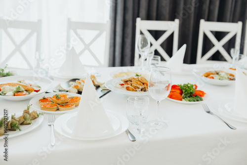 Elegant dining setup with gourmet dishes and decorative table linens