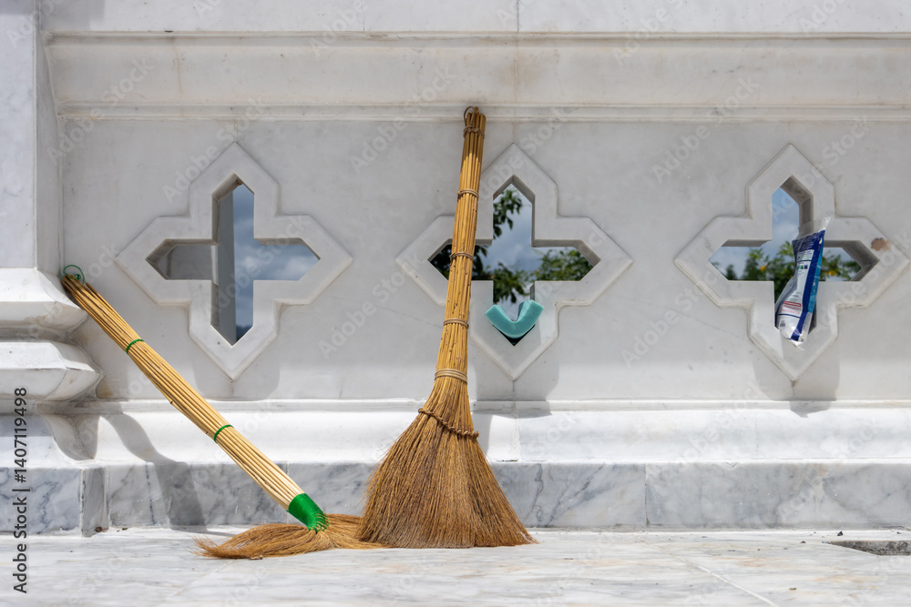 Brooms on the terrace of a Buddhist temple in Thailand