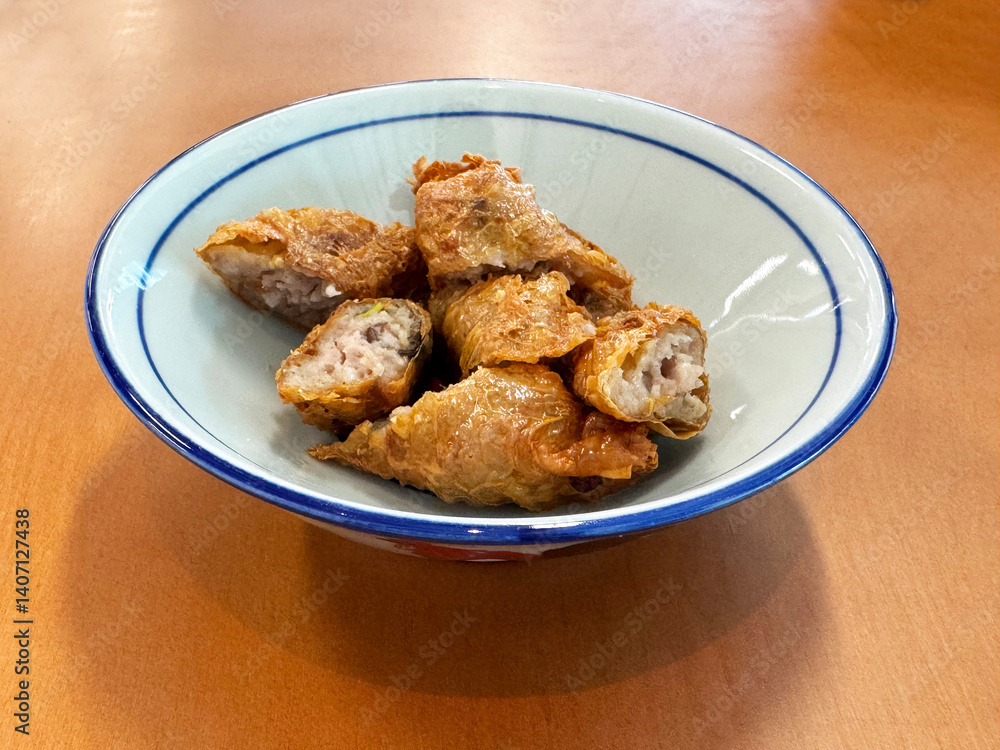 traditional asian deep fried crispy golden chicken wu xiang meat vege roll appetiser in white bowl on wood table chinese dim sum snack cafe halal menu food restaurant