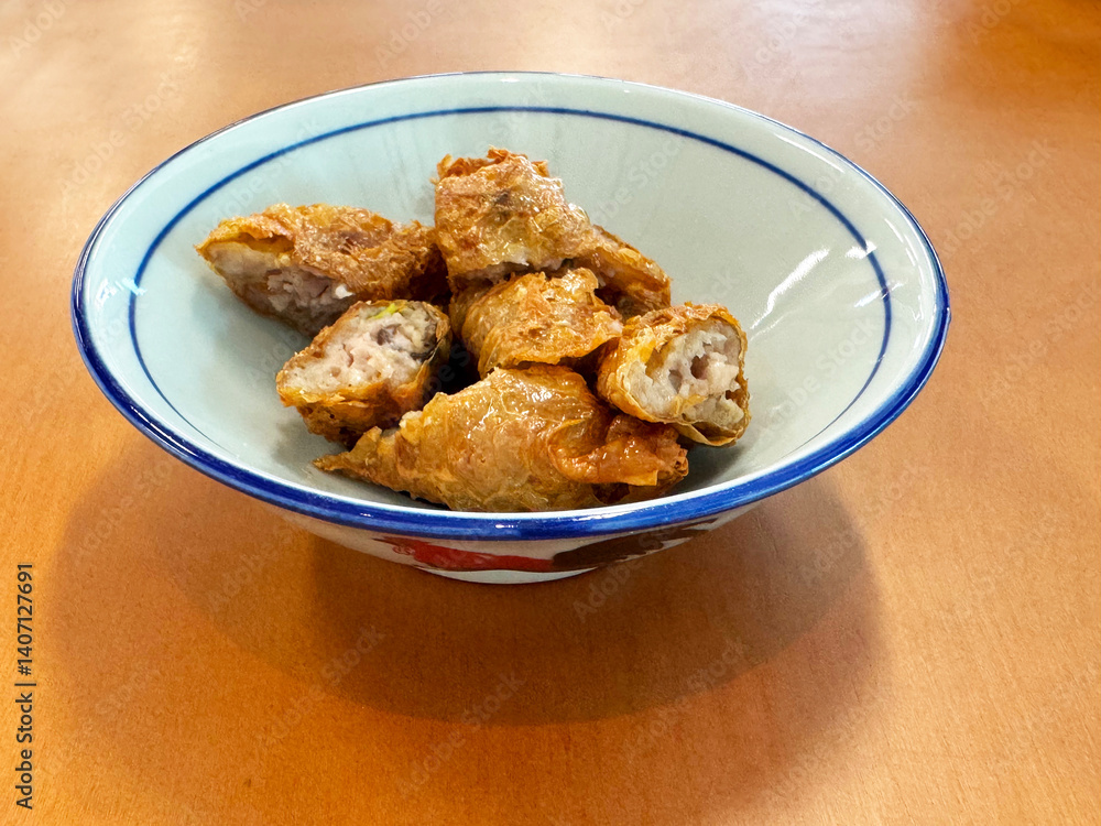 traditional asian deep fried crispy golden chicken wu xiang meat vege roll appetiser in white bowl on wood table chinese dim sum snack cafe halal menu food restaurant