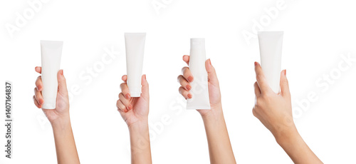 Female hand holding blank cosmetic bottle isolated on white background