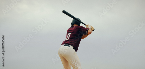 Baseball player poised to hit the pitch, showing concentration and readiness at the batter's box