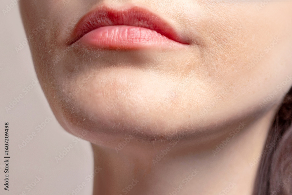 Obraz premium A woman's chin grows blonde and dark hair. Woman's beard grows. Cropped close up photo