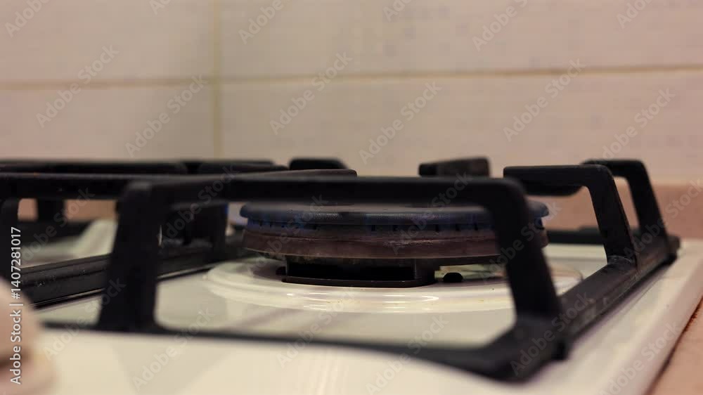 A Close-Up Of A Kettle Being Removed From A Gas Stove Burner, Followed By The Burner Being Turned Off In A Domestic Kitchen Setting. A Close-Up Of A Kettle Being Removed From A Gas Stove Burner, Followed By The Burner Being Turned Off In A Domestic Kitchen Setting.