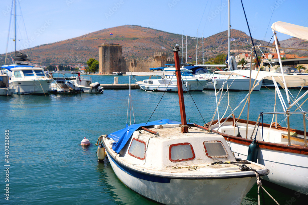 Beautiful old buildings, boats and yachts on the promenade in Trogir, Croatia. Sunny summer day in Trogir.