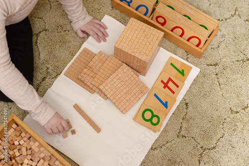 Child Learning Math with Montessori Materials