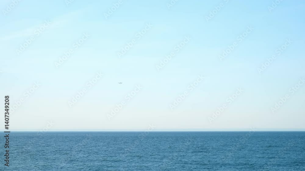 Airplane plane flying over the sea in clear blue sky at sunny weather. Passenger jet approaching to land at airport. Tourism, travel, journey, wanderlust concept, air flight. Calm blue sea on summer. Airplane plane flying over the sea in clear blue sky at sunny weather. Passenger jet approaching to land at airport. Tourism, travel, journey, wanderlust concept, air flight. Calm blue sea on summer.
