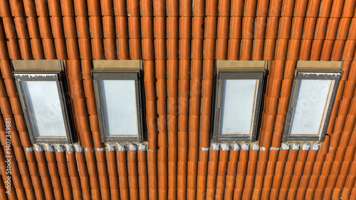 Obraz na płótnie Aerial view of 4 small windows on the roof of a building. w salonie
