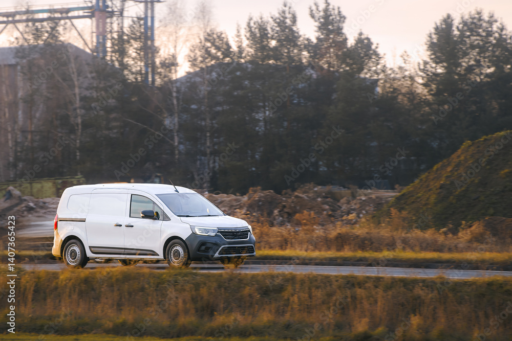 Van on countryside road in sunlight
