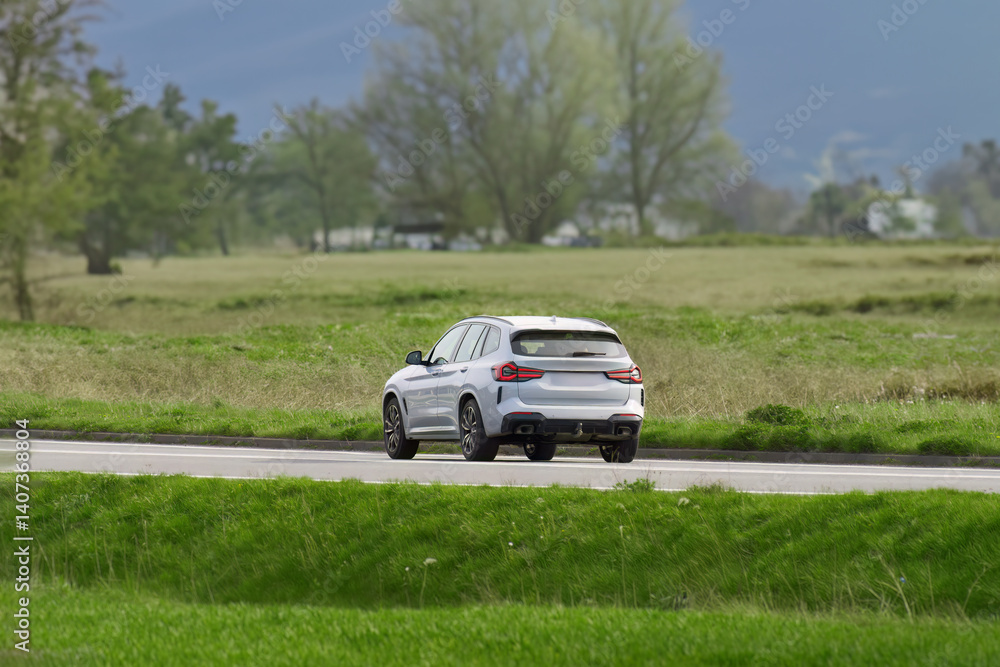 Luxury SUV cruising on a country road