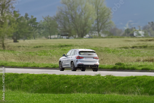 Obraz na płótnie Luxury SUV cruising on a country road w salonie