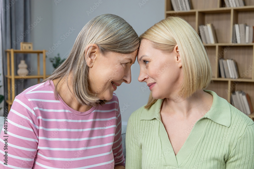 Smiling women hugging each other, smiling and feeling close Smiling women hugging each other, smiling and feeling close