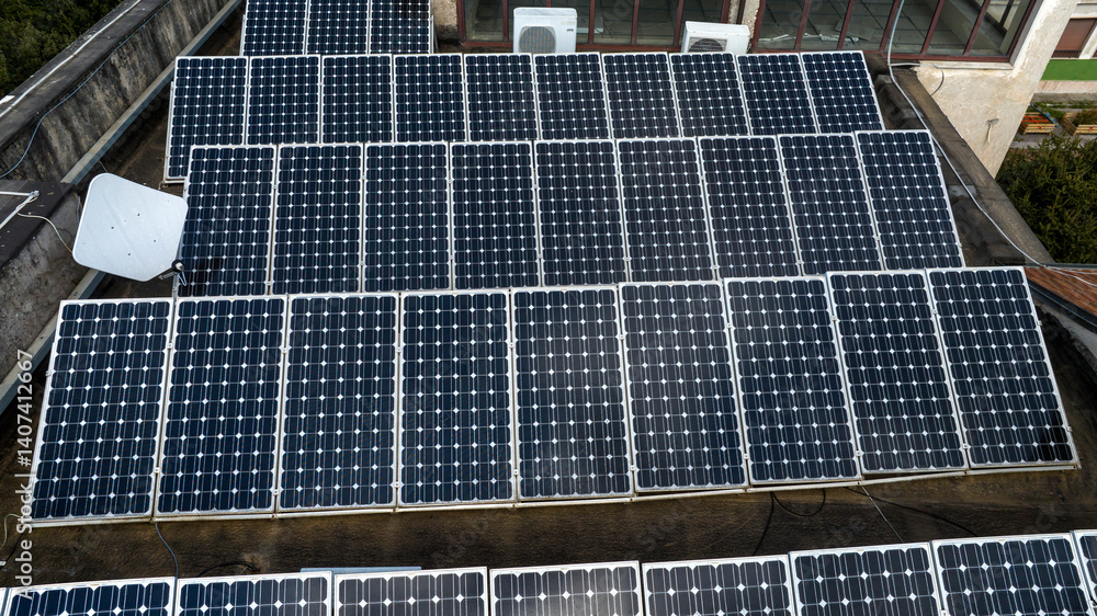 Aerial view of modern solar panels on the roof of a building.