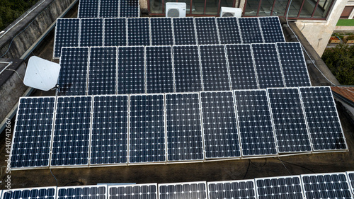 Aerial view of modern solar panels on the roof of a building.