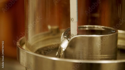 Close-Up of Copper Distillation Apparatus with Pressure Gauge and Viewing Ports