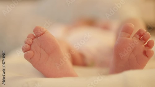 Baby, new life, cute concept. Feet and legs of calm newborn baby