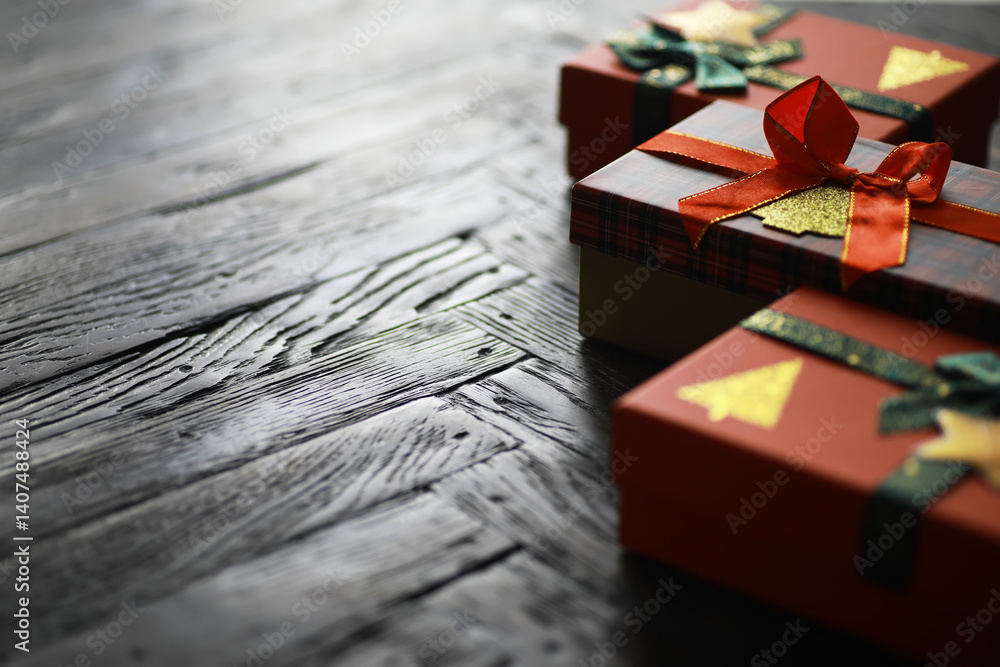 Fototapeta premium Festive Wrapped Holiday Gift Boxes with Red Ribbons and Tree Decorations on Wooden Table