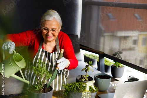 One woman, mature female taking care of her plants in back yard of her home.