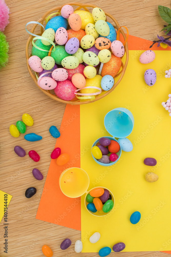Bright background with candies in the form of Easter eggs in plastic eggs. Egg hunt concept. Happy Easter. Top view. Bright background with candies in the form of Easter eggs in plastic eggs. Egg hunt concept. Happy Easter. Top view.