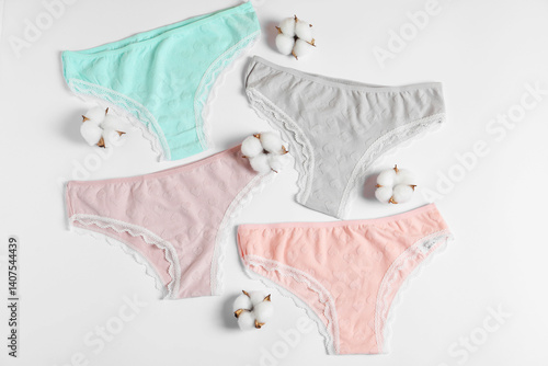 Obraz na płótnie Women's underwear. Beautiful panties and cotton flowers on white background, flat lay w salonie