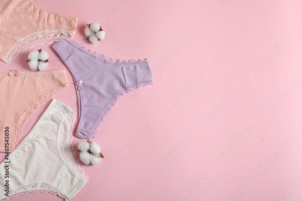 Women's underwear. Beautiful panties and cotton flowers on pink background, flat lay. Space for text